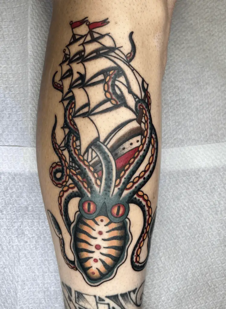 Colored Kraken Holding the Pirate Ship Leg Tattoo