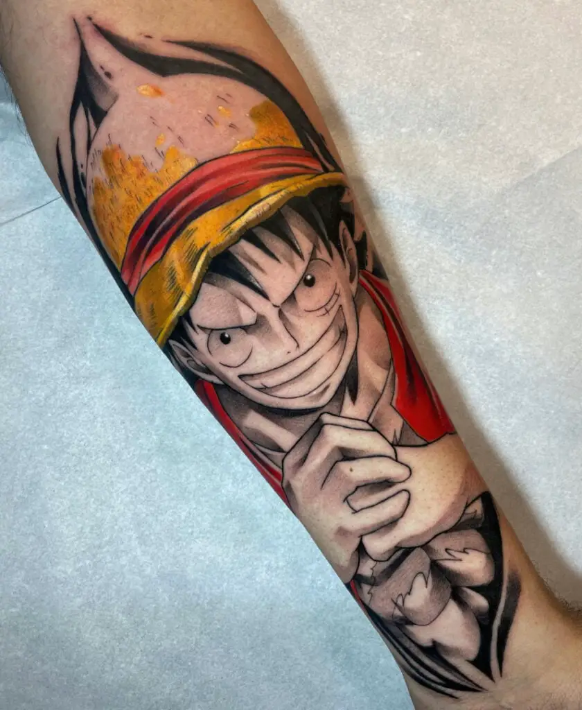 Colored Luffy Grinning While Holding His Fist Arm Tattoo