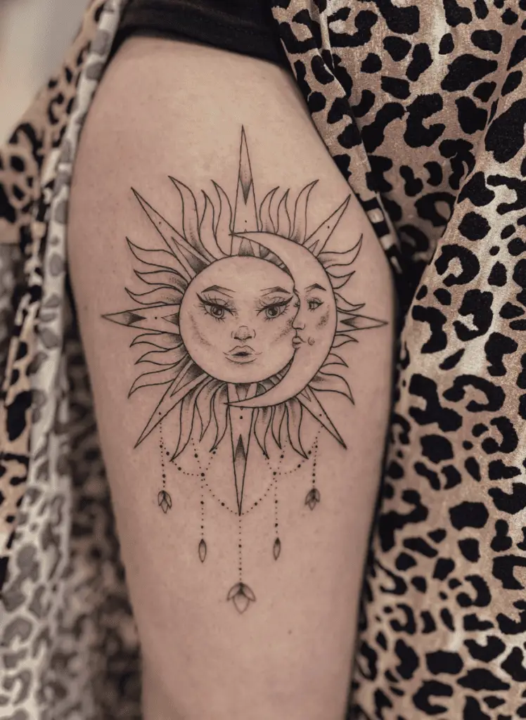 Gorgeous Sun and Moon Faces With Embelishments Upper Arm Tattoo