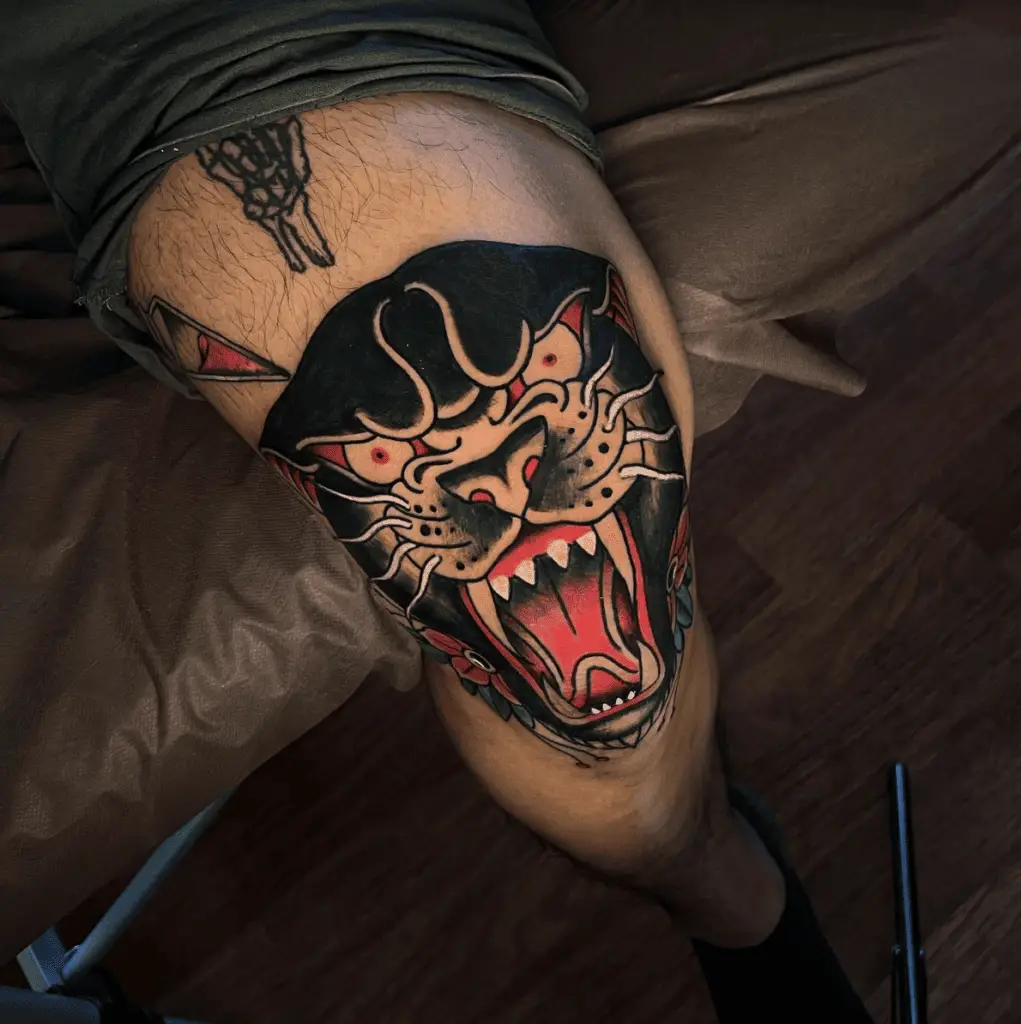 Red Detailed Black Raging Panther Face Knee Tattoo