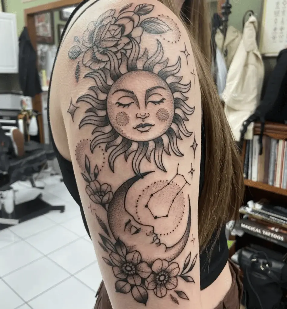 Sleeping Sun and Moon Surrounded by Flowers, Stars and Constellations Arm Tattoo