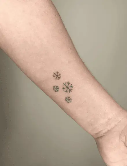 Tiny Snowflakes Icons Wrist Tattoo