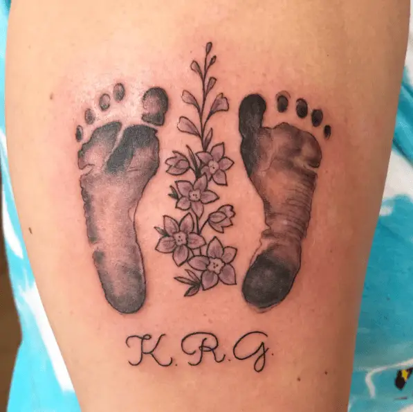 Double Footprints with Initials and Flowers Tattoo