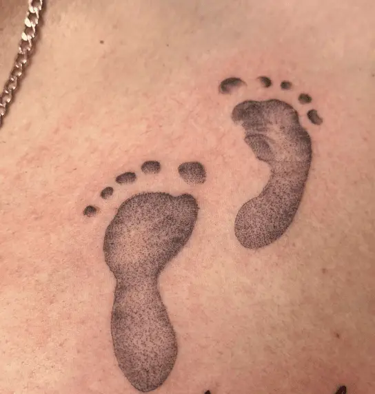 Double Baby Footprints Chest Tattoo