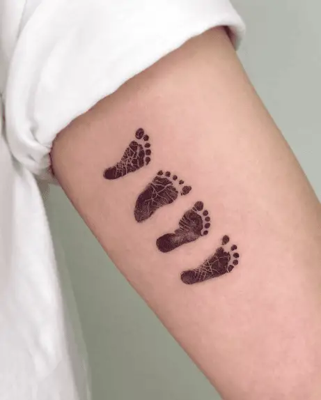 Black Ink Four Types of Footprints Arm Tattoo