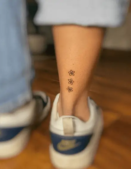 Three Tiny Flowers Leg Tattoo