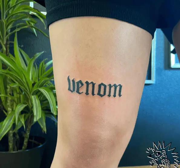 Venom Lettering Thigh Tattoo