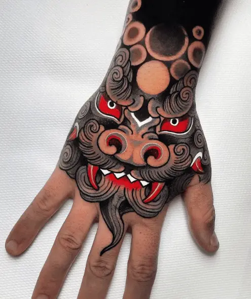 Black and Red Ink Foo Dog Hand Tattoo 