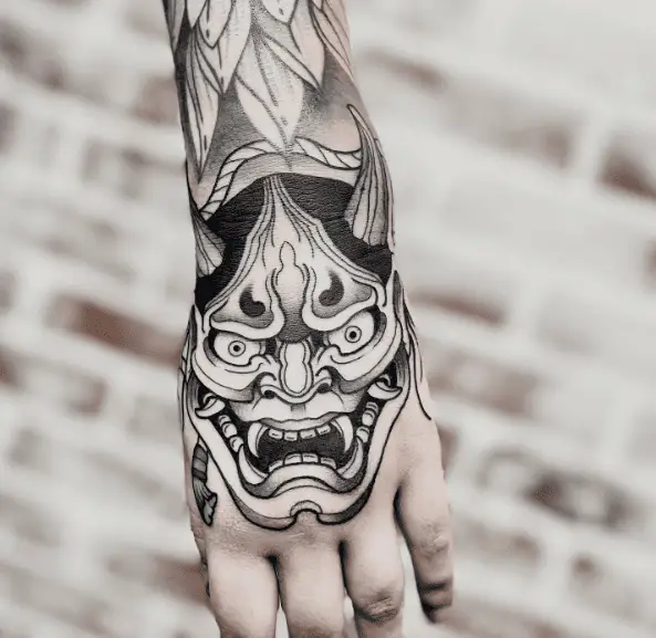 Black and Grey Demon Mask Hand Tattoo