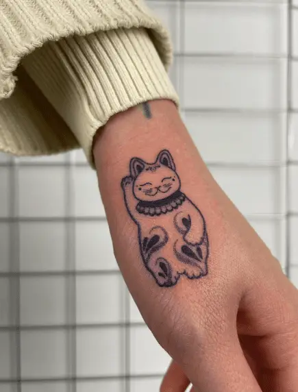 Small and Cute Maneki Neko Hand Tattoo