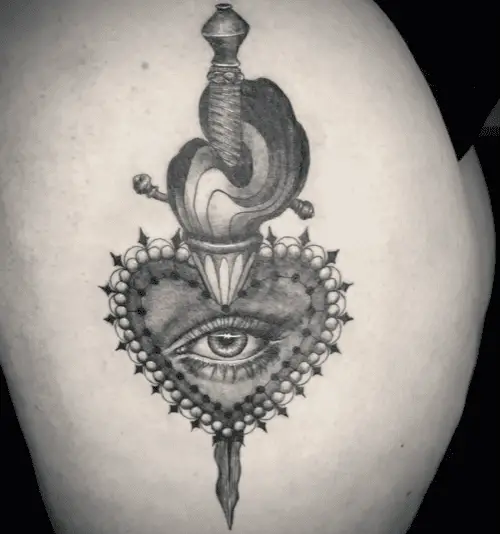 Black and Grey Sacred Heart Eye With Wavy Dagger Thigh Tattoo