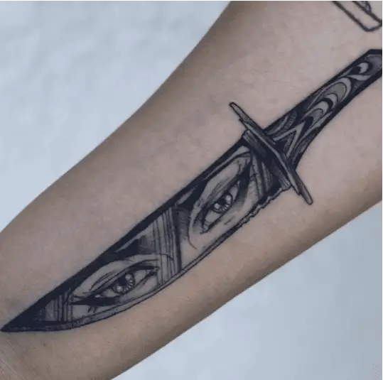 Black and Grey Female Eyes in Knife Arm Tattoo