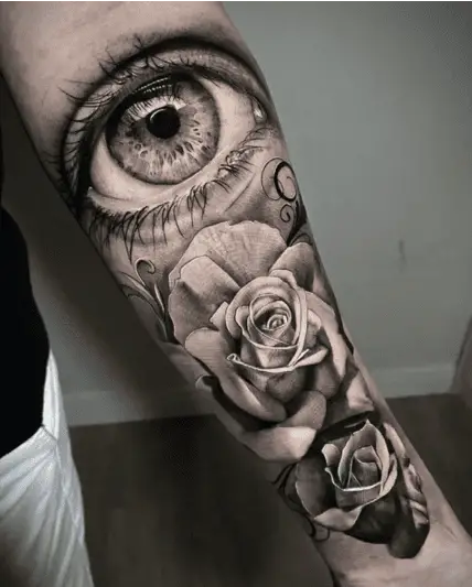 Realistic Eye With Roses Arm Tattoo