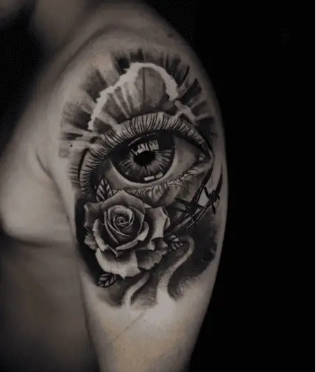 Black and Grey Realistic Eye and Rose With Rays Upper Arm Tattoo