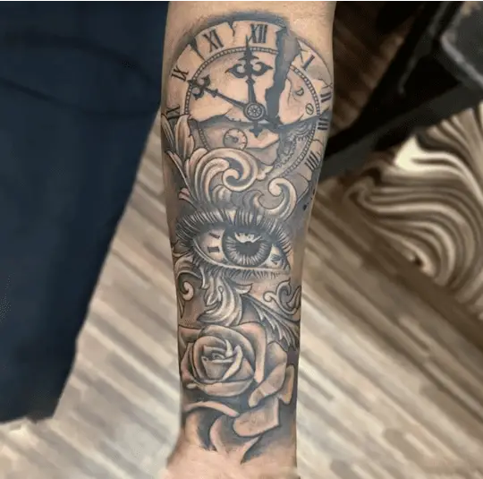 Black and Grey Eye With Broken Clock and Rose Aligned Vertically Arm Tattoo