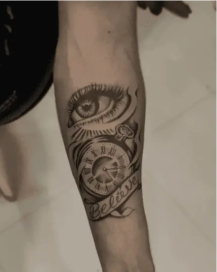 Black and Grey Eye and Vintage Clock With Text Banner Arm Tattoo