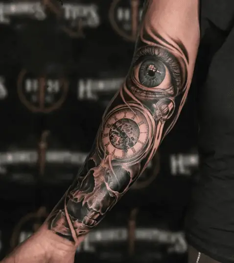 Realistic Green Eye and Vintage Clock and Skull Arm Tattoo