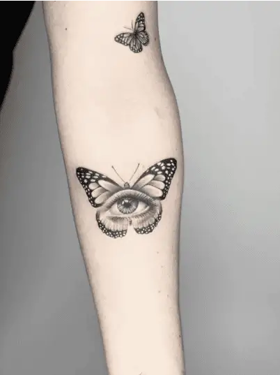 Detailed Butterfly Eye Arm Tattoo