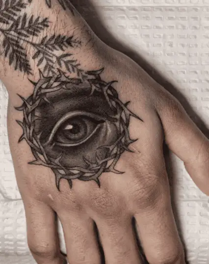 Black and Grey Eye Surrounded by Thorns Hand Tattoo