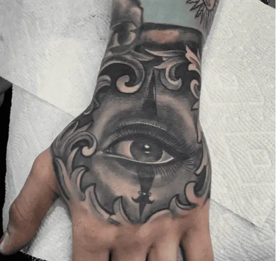Black and Grey Eye Surrounded by Leaves Hand Tattoo