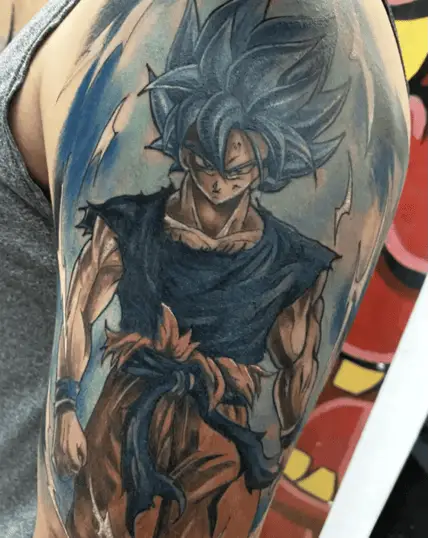 Colored Son Goku Standing and Emitting a Powerful Energy Upper Arm Tattoo
