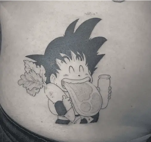 Happy Kid Son Goku With Meat on His Mouth While Holding a Carrot and Glass Tummy Tattoo