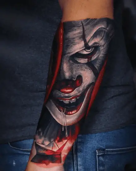 Drooling Pennywise Clown and Paper Boat Forearm Tattoo