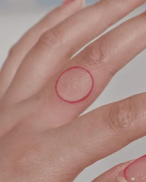 Red Ink Circle Finger Tattoo