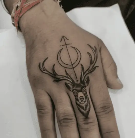 Crescent Moon and Arrow at Top of Deer Head Hand Tattoo