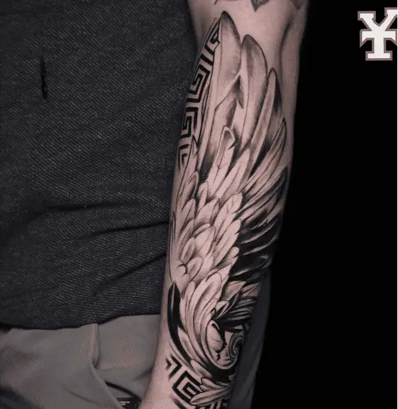 Black and Grey Angel Wing With Tribal Pattern Arm Sleeve Tattoo