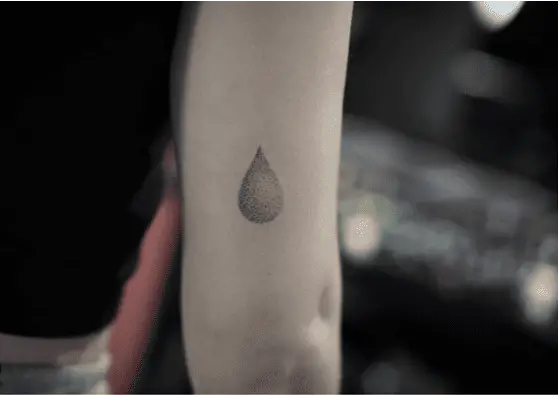 Dotted Single Rain Droplet Arm Tattoo