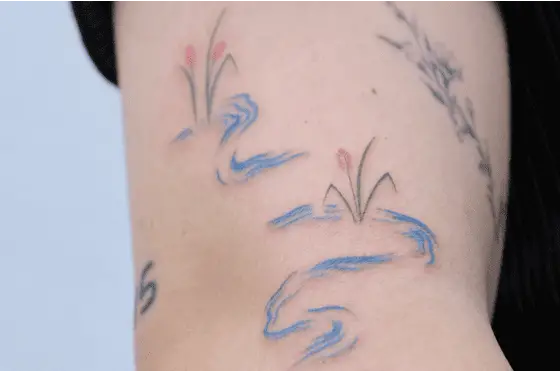Delicate River with Flowers Arm Tattoo