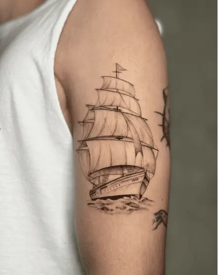 Ship Passing Through the Ocean Upper Arm Tattoo