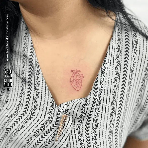 Tiny Red Ink Organ Heart Chest Tattoo