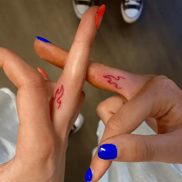 Tiny Red Ink Twin Flame Finger Tattoo