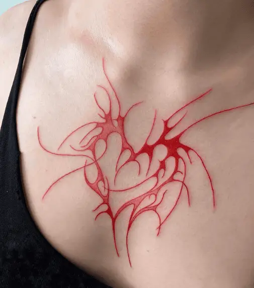 Red Ink Splashing Heart Shaped Chest Tattoo
