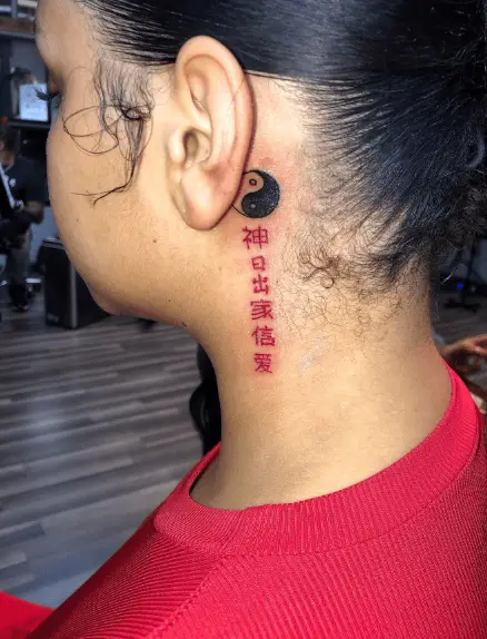 Red Ink Chinese Symbols Tattoo Behind the Ear