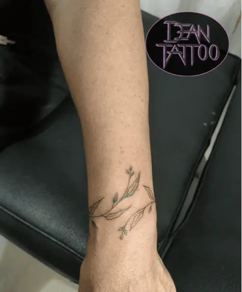 Minimalist Vine Wrist Tattoo
