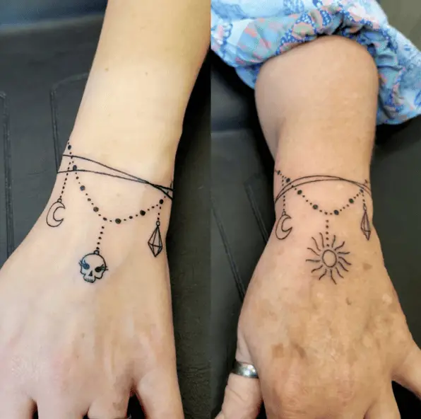Skull Pendant on Left Hand and Sun Pendant on Right Hand with Moon and Diamond Bracelet Tattoo