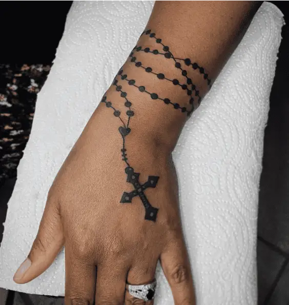 Black Rosary and Small Heart Wrapped Around a Wrist Tattoo