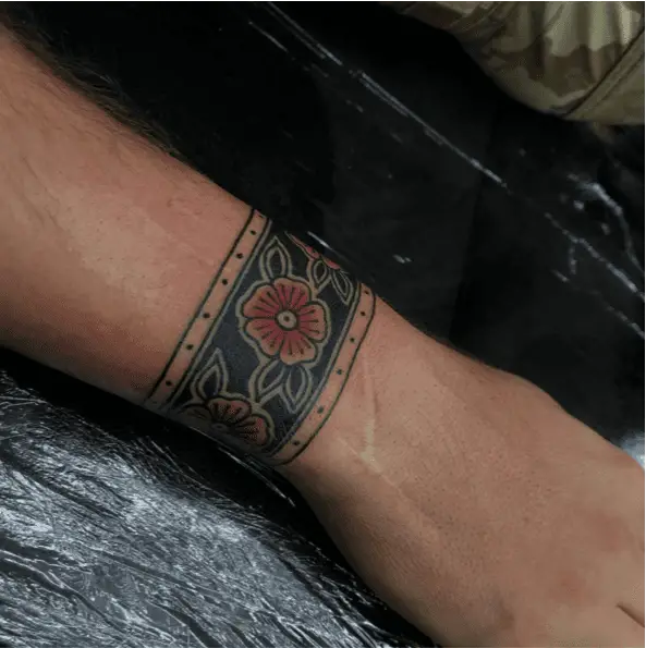 Traditional Three Red Flower Heads in Black Wrist Band Tattoo