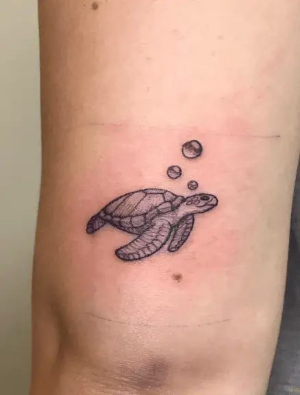 Tiny Greyish Swimming Sea Turtle Tattoo