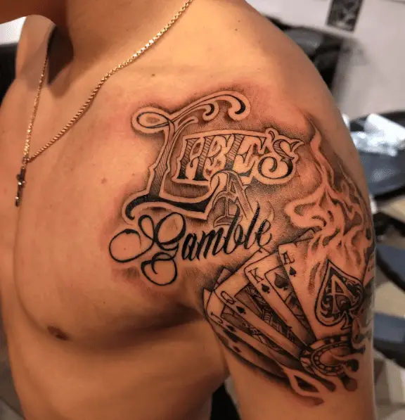 Life's a Gamble Text with Burning Cards Shoulder Tattoo