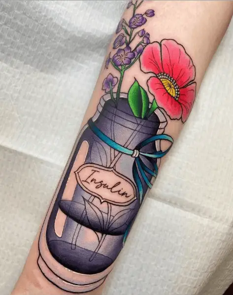 Tattoo of a Beautiful Flower Arrangement Inside a Bottle of Insulin