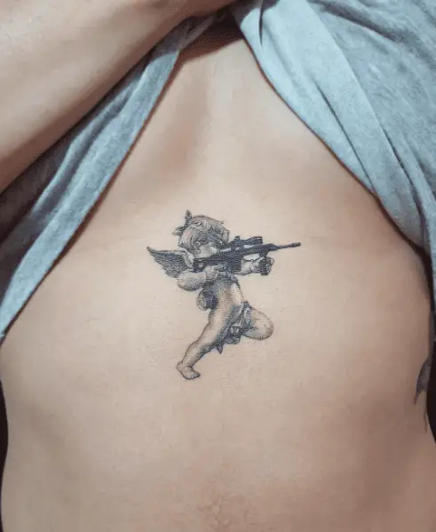 Tiny Cupid with Gun Sternum Tattoo