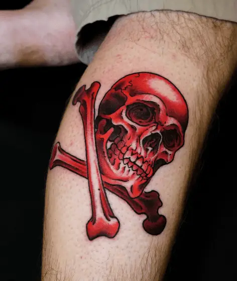 Vibrant Red Ink Skull and Crossbones Tattoo