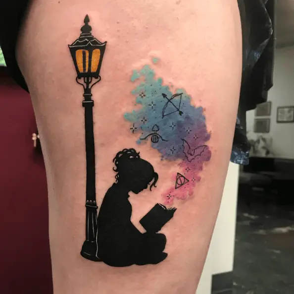 Tattoo of a Little Girl Reading Book Beside Street Lamp