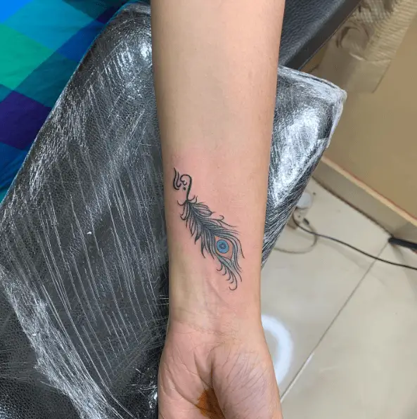 Black Ink Peacock Feather Wrist Tattoo