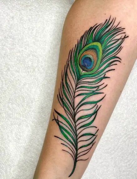 Vibrant Green Peacock Feather Forearm Tattoo
