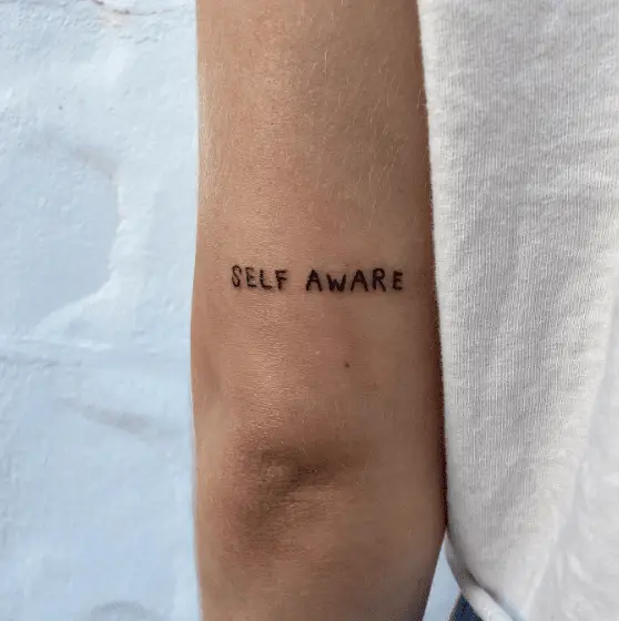 Self Aware Lettering Tricep Tattoo